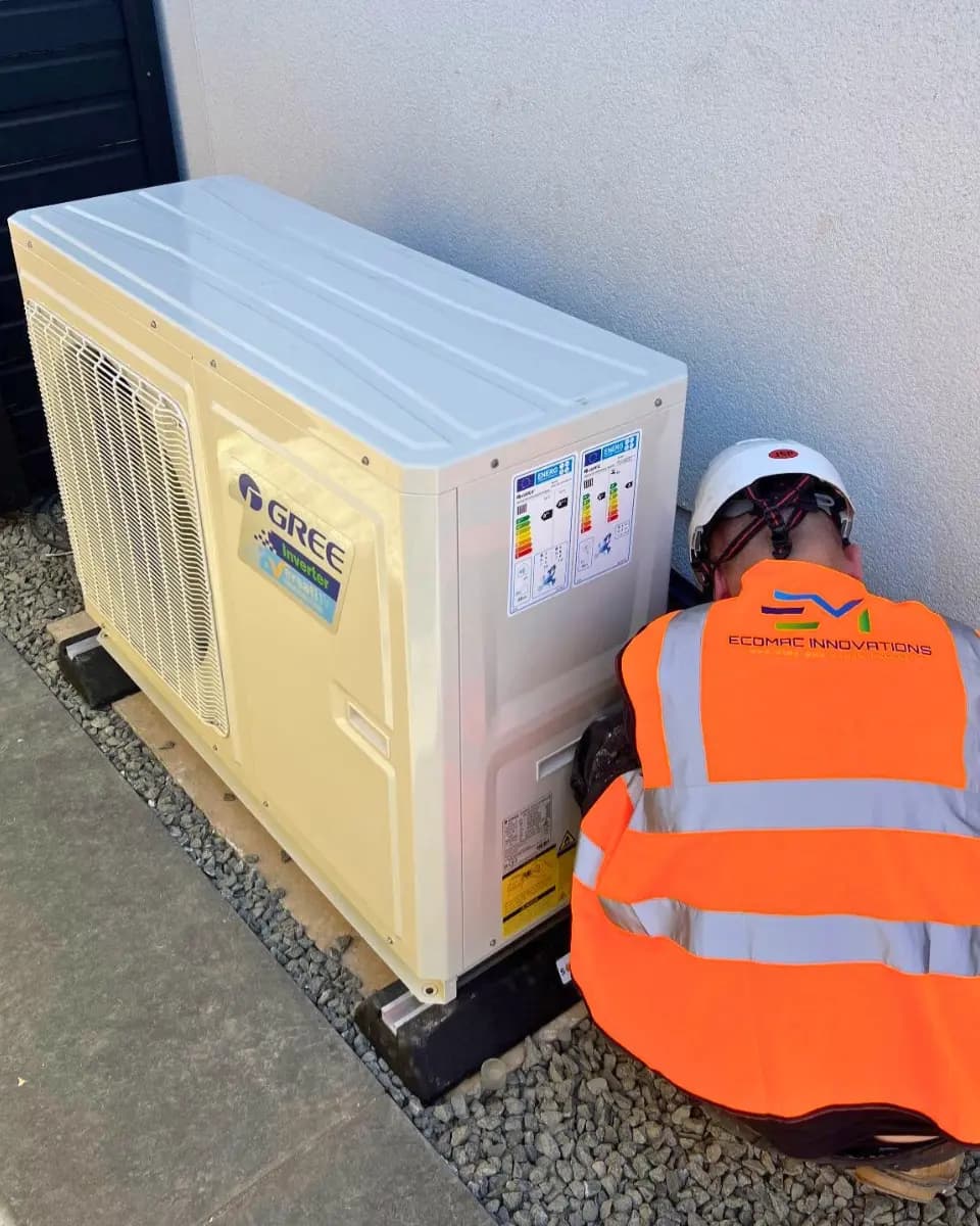 Ecomac installer fitting an air source heat pump at a residential property in Scotland